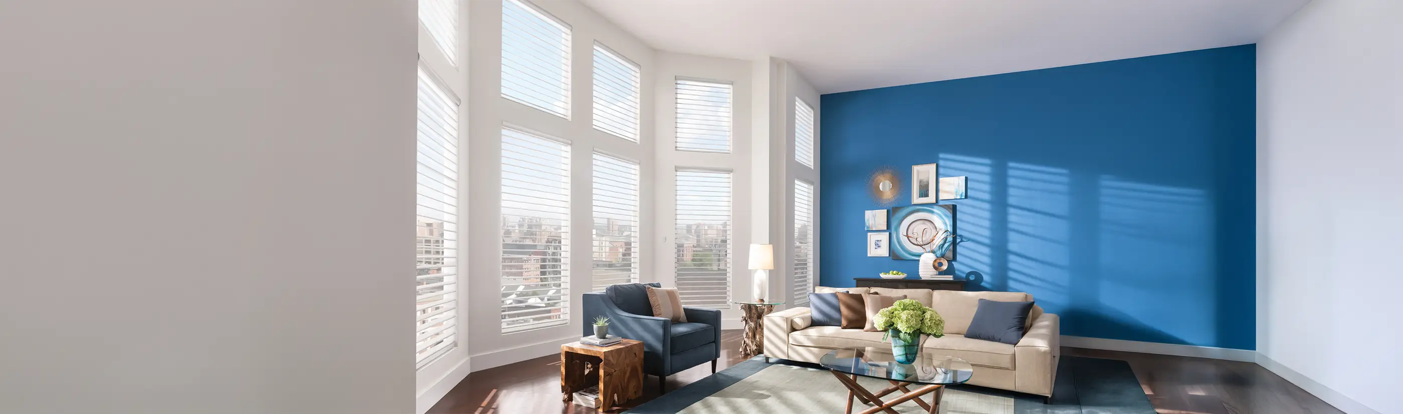 white sheer shades in 10 windows in a large living room with a blue accent wall 