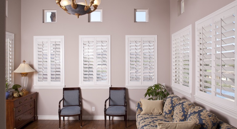 Chic sunroom with white shutters