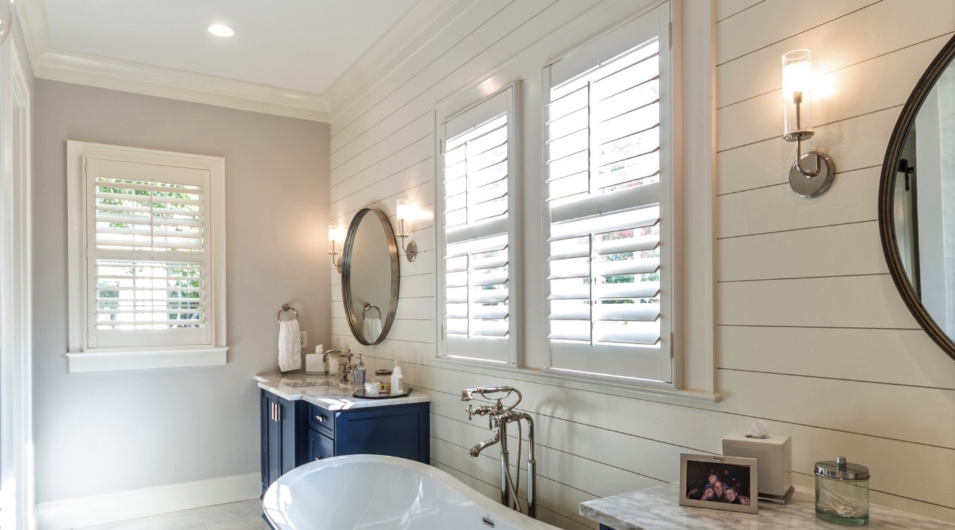 Hartford bathroom with white plantation shutters.