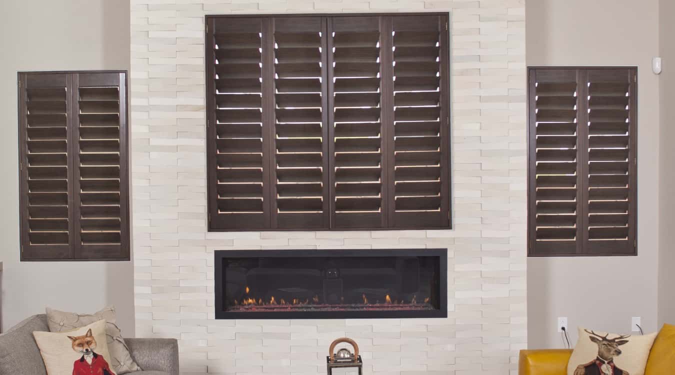 Wood shutters in living room with fireplace