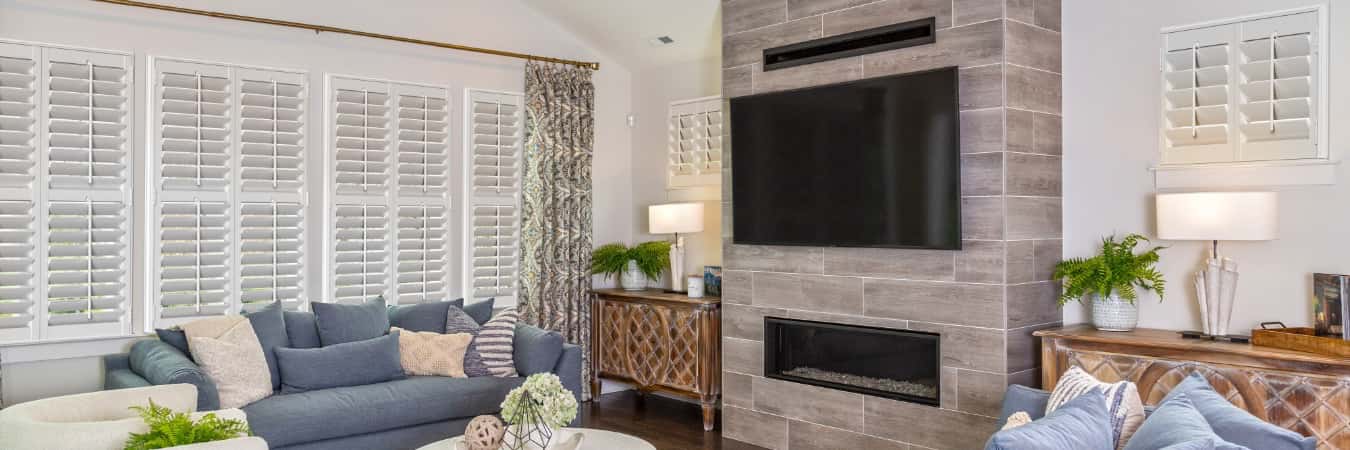 Plantation shutters in East Haven family room with fireplace