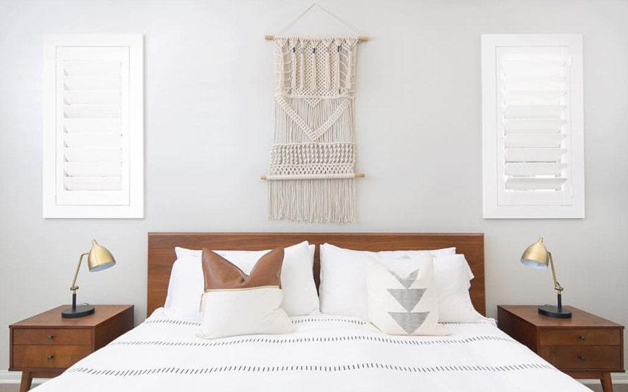 Custom-fitted louvered shutters provide excellent nighttime privacy in Hartford. Photo Credit: Audrey Crisp Louvered shutters in a bedroom.