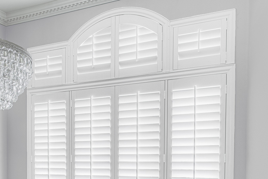 Customize your Palladian windows with white Polywood shutters in Hartford. White Polywood Palladian windows in a dining room.
