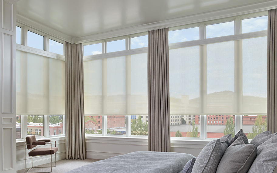 White sheer shades in a bedroom.