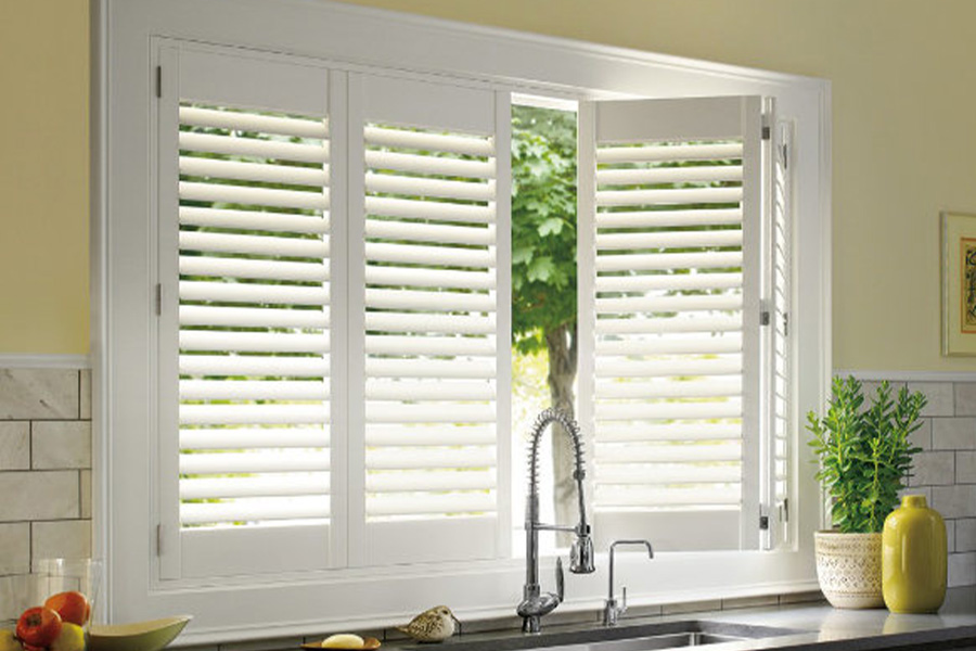 Polywood shutters are built to withstand the test of time in Hartford. White Polywood shutters above a kitchen sink.