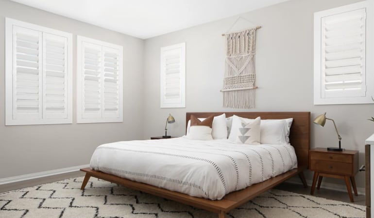 Open shutter louvers will help any Hartford room feel larger. Plantation shutters in a model home bedroom.