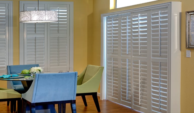 Plantation shutters on a French door function like common window shutters. Patio Doors with Plantation Shutters in Hartford