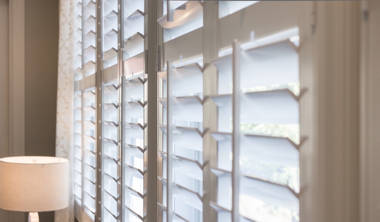 East-West windows can have glare problems from sunrises and sunsets. Plantation shutters close up