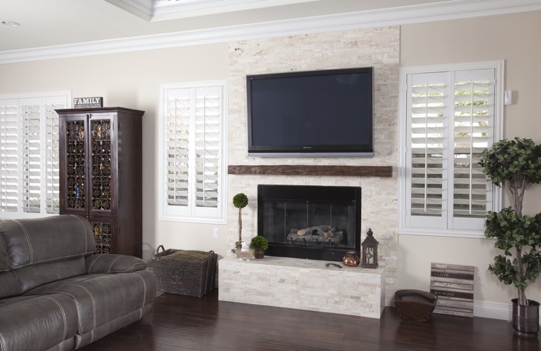 White plantation shutters in a Hartford living room with solid hardwood floors. White plantation shutters in a Hartford living room with solid hardwood floors.