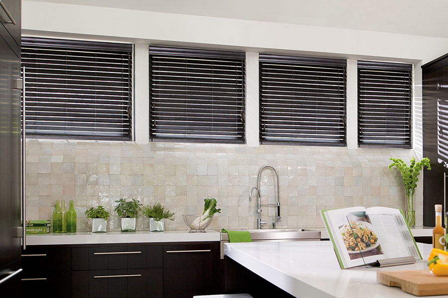 Choose custom Polywood faux wood blinds for your kitchen in Hartford. Special shaped faux wood blinds in several windows above a sink.