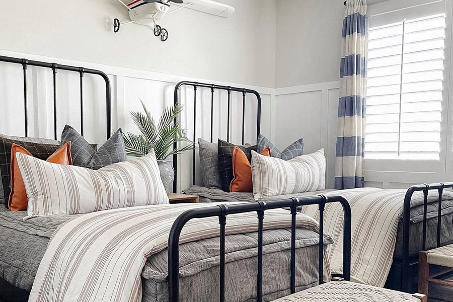 Interior shutters are sturdy and child-safe around your children. Photo credit: @greybirchdesigns Kid's bedroom with white Polywood shutters