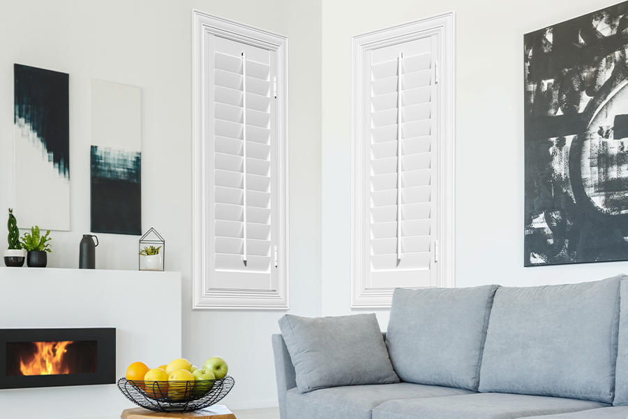 White Polywood shutters add character and class in Hartford. White polywood shutters in a corner of a modern living room.