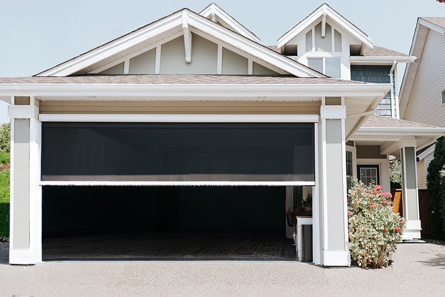 If you spend a lot of time in your garage, a retractable screen is a must! A screen shade partially lowered over a garage door