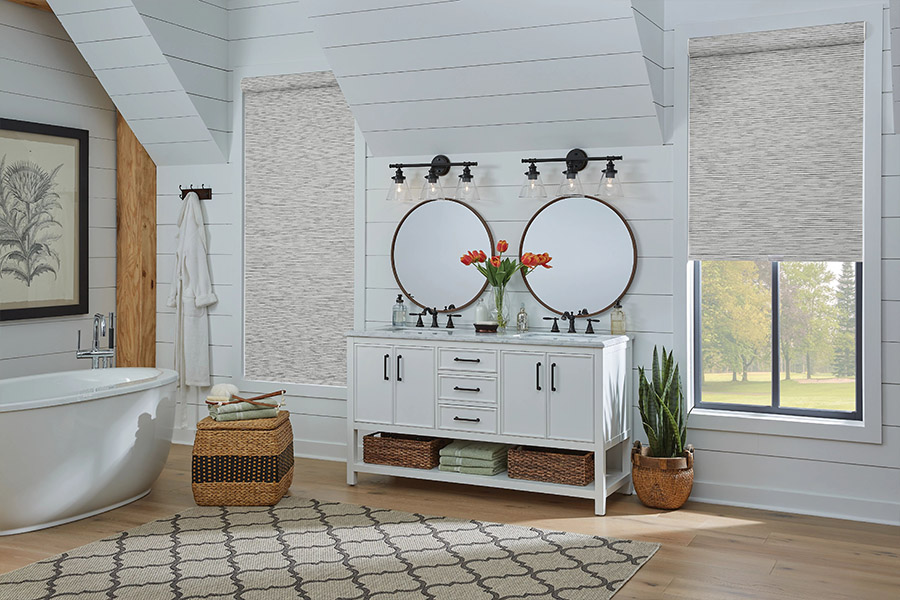 Slim-profile roller shades easily fit shallow windows in your Hartford home. Gray patterned roller shades on bathroom windows
